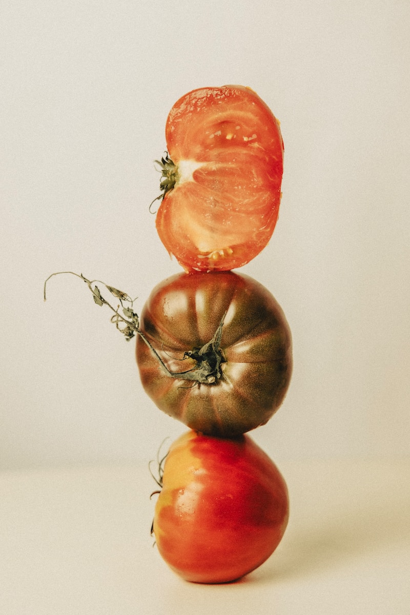 a tomato balancing on top of another tomato